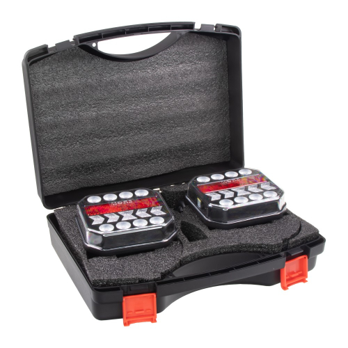 Dve bezdrôtové zadné LED lampy uložené v otvorenom prepravnom kufríku s tvarovanou penovou výplňou